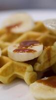 Pour caramel onto waffles pouring honey or maple syrup onto Belgian waffles. video