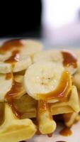 Delicious Belgian waffles with banana, whipped cream and caramel sauce video