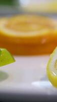 Making lemonade, summer drink, cold drink, healthy liquid. Lemon orange lime, making a cocktail of citrus fruits, drinking cold lemonade, shooting of carbonated water with sliced fruits. video
