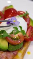 Egg benedict with hollandaise sauce and smoked salmon on toast Eggs Benedict with bread and tomato on a plate with becon morning sandwich video