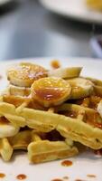 Delicious Belgian waffles with banana, whipped cream and caramel sauce video