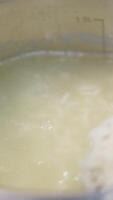Cook rice in a saucepan Cooking rice. A wooden spoon stirs the rice in boiling water. Food preparation. A series of footage to visualize the recipe. video