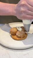 Confectionery decorate cake Pastry chef decorates biscuit tartlet with cream from pastry bag, close-up. Preparation of cake at commercial bakery with piping bag. High quality 4k footage. video