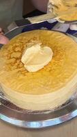 Spread cream on thin pancakes Spread thin pancakes with chocolate or cream paste. Pancakes with boiled condensed milk and banana filling video