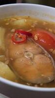 Fish soup with red fish Finnish fish soup with red fish with spices and fresh dill on a dark stone background. Top view with copy space. video