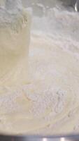 stir flour into batter Adding flour to cookie batter and stirring with wooden spoon video