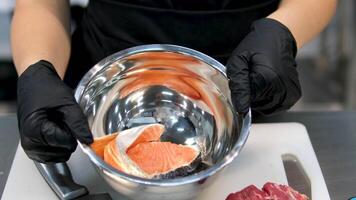 Freshly cut, oiled and marinated salmon in a black pan on a 360 degree rotating showcase. Healthy food Fresh Salmon Red Fish for Steak. 4k. Close-up slow-motion of sliced fresh raw red salmon. video