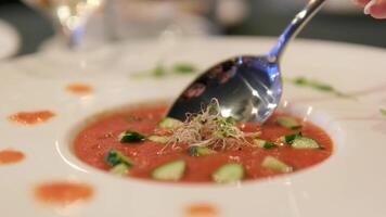 tomato soup Stirring tomato soup with bread roll flat lay medium slow motion shot selective focus video
