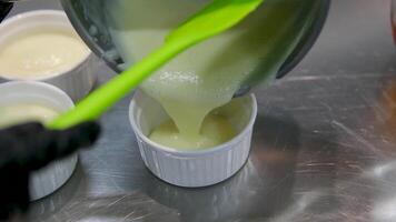 pour cream into a plate Lemon pudding or lemon curd served with mint leaves and sliced lemon recipe. Serving pudding in a glass bowls video