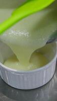 pour cream into a plate Lemon pudding or lemon curd served with mint leaves and sliced lemon recipe. Serving pudding in a glass bowls video