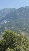 mountains of Albania view of mountains following cars from the window shooting while the car is moving video