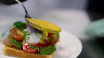 Egg Benedict sauce Delicious eggs benedict served on a white plate for an appetizing and nutritious breakfast, Eggs for breakfast with white hollandaise sauce video