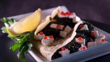 appetizer with caviar Red and black caviar with lemon, feta cheese and lavash video