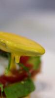 Egg Benedict sauce Delicious eggs benedict served on a white plate for an appetizing and nutritious breakfast, Eggs for breakfast with white hollandaise sauce video