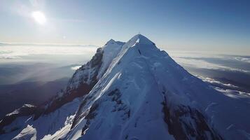 Majestic Aerial View of Snow-Capped Mountain Peak with Climbers and Dramatic Shadows photo