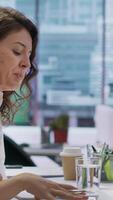Vertical HR experts going through the selection process after the job interviews, carefully choosing the right candidate based on their CV. Professional employers reviewing qualifications. Camera A. video