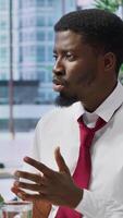 Vertical HR professional staff engages in an interview with applicant with disability, focusing on the qualifications written in the CV. Looking to integrate his talent within the organization. Camera A. video