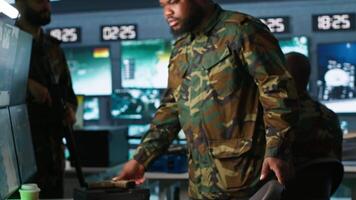 Intelligence corps expert in military HQ base gathering information on enemy troops. Officer arriving at work in base of operations, starting assessment of enemy vulnerabilities, tracking, camera A video