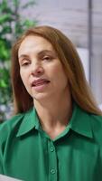 Vertical HR recruiter examines a candidate resume during a formal job interview, evaluating their qualifications during selection and recruitment process. Talent acquisition and recruiting. Camera A. video