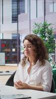 Vertical African american HR recruiter interviewing female candidate for a vacancy, asking her about past work experience and career achievements. Interviewer recruiting personnel. Camera B. video