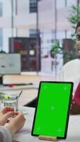Vertical Job applicant and employer discussing in an interview with isolated mockup display on a device, high end corporate office. Businessman and HR recruiter share career development ideas. Camera B. video