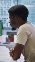Vertical HR manager conducting a detailed interview with a potential candidate in a modern office, discussing qualifications, previous experience and career goals. Headhunter studies CV. Camera A. video