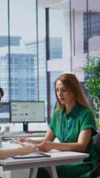 Vertical Human resources employees evaluating the job applications and CVs after the interviews, choosing the best candidate to fill in the corporate position. Selection process for employment. Camera B. video