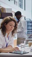 Vertical HR experts going through the selection process after the job interviews, carefully choosing the right candidate based on their CV. Professional employers reviewing qualifications. Camera B. video