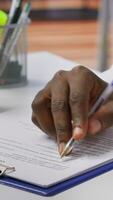 Vertical Job candidate signing his work contract and securing a corporate position, reading the employment agreement terms. Businessman applicant finding a new job within company. Close up. Camera A. video