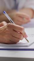 Vertical HR recruiters interviewing a job seeker and taking notes during meeting, attending an interview and conducting an evaluation. Headhunters and applicant in recruitment process. Close up. Camera A. video