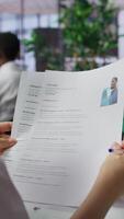 Vertical HR employers analyzing candidate CV after the job interview, carefully evaluating all qualifications and business administration knowledge or experience. Selection process for employment. Camera B. video