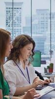 Vertical Job candidate sits across from interviewers team in high end office, presenting qualifications and discussing various job opportunities or career paths within the company. Employment. Camera B. video