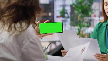 HR team selecting candidates and using a copy space mockup display in high end office, working on finding the best applicant for the job opening. Recruiters review resumes. Camera A. video