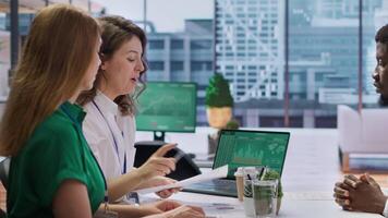 Applicant gives his CV to human resources staff to begin the job interview, reviewing the qualifications and work experience from the application form. Discussing job roles available. Camera A. video