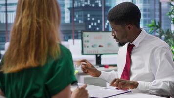 New employee signing his work contract after successful job interview with the HR staff, businesswomen shaking hands and welcoming man to the team. Job applicant securing a position. Camera A. video