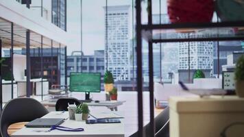 Empty modern office workspace designed for job interviews to achieve business success, professionals using advanced technology for resumes selection during recruitment process. video