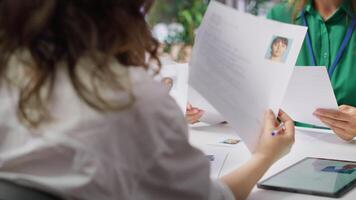 Human resources staff evaluating candidates resume in the selection process, reviewing all applicants after job interview in order to hire the right person. Recruiters seeking personnel. Camera A. video