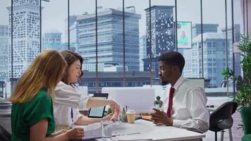 Male job candidate filling in his application form in high end office, attending an interview for a job offer within a corporation. Businessman writing his information on document. Camera B. video
