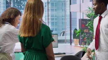 HR recruiters team greeting a job candidate at an interview with a handshake, professionals reviewing the work experience based on the resume information. Interviewers seeking talent. Camera A. video