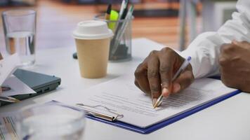 Job candidate signing his work contract and securing a corporate position, reading the employment agreement terms. Businessman applicant finding a new job within company. Close up. Camera A. video