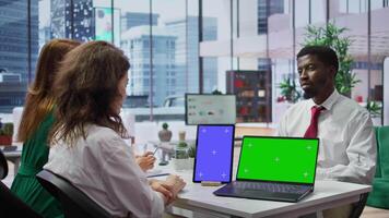 HR staff discussing with applicant next to mockup chroma key screens at the job interview, working on talent acquisition. Job seeker going through recruitment process, job search. Camera B. video