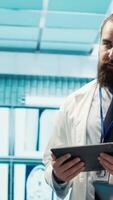 Vertical Neurology specialist examines magnetic resonance imaging brain scan with team during a meeting, looking at tomography for accurate neuroscience diagnosis. Diverse team of doctors. Camera A. video
