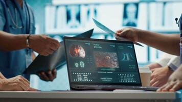 Radiologists team analyze x rays and discuss treatment options in a medical office. Team of licensed healthcare experts working together to provide diagnostic, radiology expertise. Camera A. video