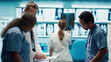 Medical professionals collaborate on human anatomy and disease diagnosis. Team of doctors with expertise in radiology and radiography support accurate treatment services, teamwork. Camera A. video