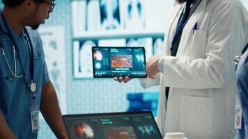 Healthcare professionals attending a strategy meeting in a medical center, focusing on treatment plans for disease prevention. General practitioner exploring healthcare initiatives. Camera A. video