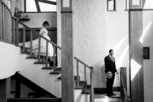the first meeting of the bride and groom on a wooden staircase photo