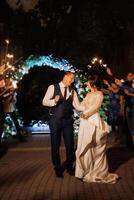 newlyweds at a wedding of sparklers photo