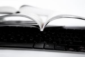 pages of journal and keyboard close-up photo