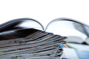 stack of newspapers, magazine, and keyboard close-up photo