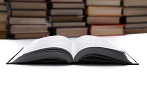open book on with pile of books photo